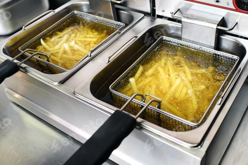 Preview: French fries or potato chips frying in oil
