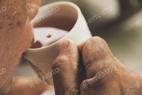 Preview: A hand ilfts a cup of tea