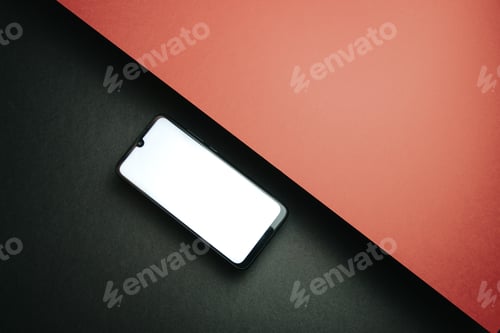 Preview: Top view of mobile phone screen blank template on black and red background with copy space