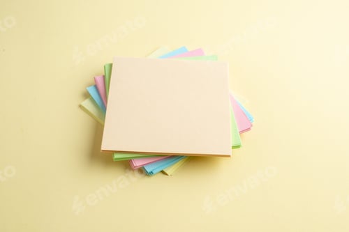 Preview: Side view of stacked sticky note cubes on shaded yellow background with free space