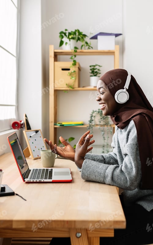 Preview: Woman in Headscarf Talks Online With Laptop