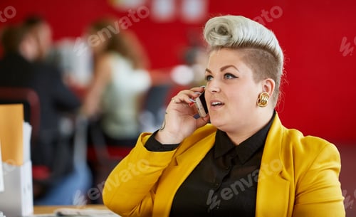 Preview: Confident female designer having a conversation on mobile phone