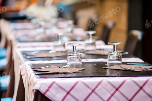 Preview: Summer empty open air restaraunt in Vatican city in Italy. Closeup wineglasses on the table