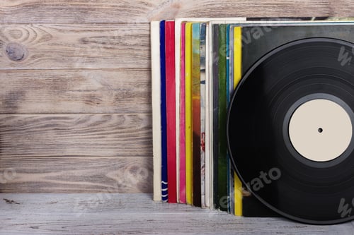 Preview: Retro styled image of a collection of old vinyl record lp's with sleeves