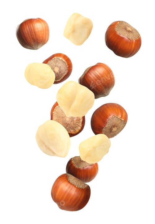 Preview: Tasty hazelnuts falling on white background. Healthy snack
