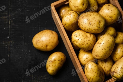 Preview: Fresh potatoes. On black background.