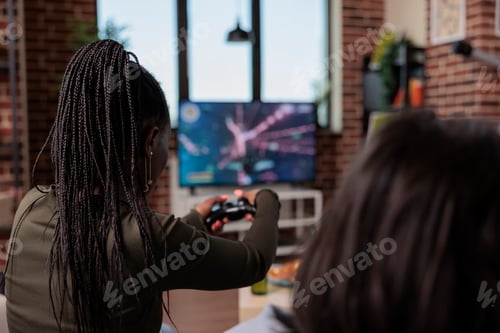 Preview: Modern person having fun with shooting video games on console