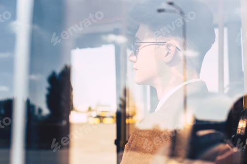 Preview: side view of man in eyeglasses riding in city bus