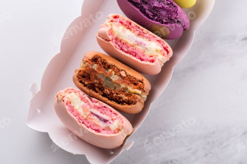 Preview: Nibbled French macarons cookies in a box, top view