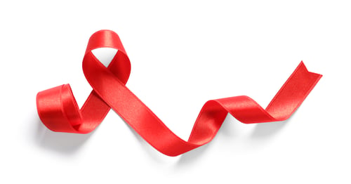 Preview: Red ribbon on white background, top view. Cancer awareness