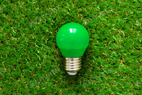 Preview: Energy efficient light bulb lying on grass