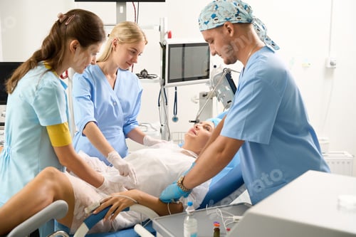 Preview: Doctor and nurses examining and put drop counter to pregnant woman
