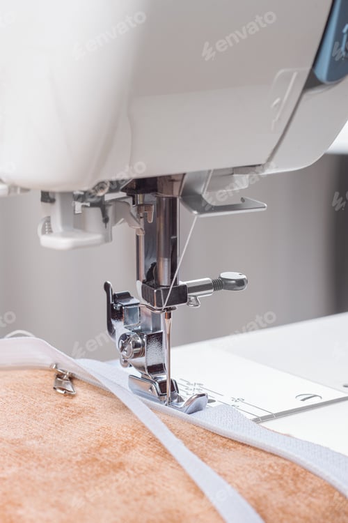 Preview: Modern Sewing Machine Special Presser Foot With Beige Fabric And Zipper, Closeup