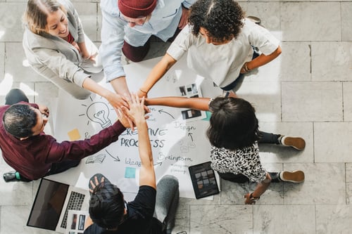 Preview: Diverse startup business team stacking hands