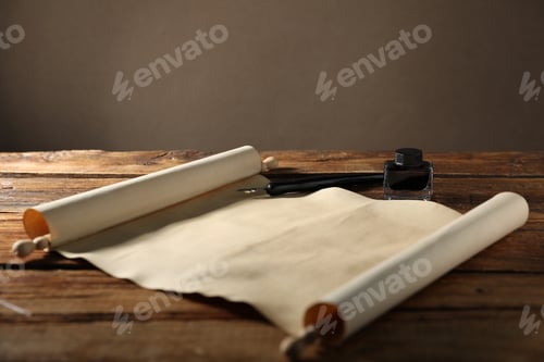 Preview: Old paper scroll, fountain pen and inkwell on wooden table, closeup