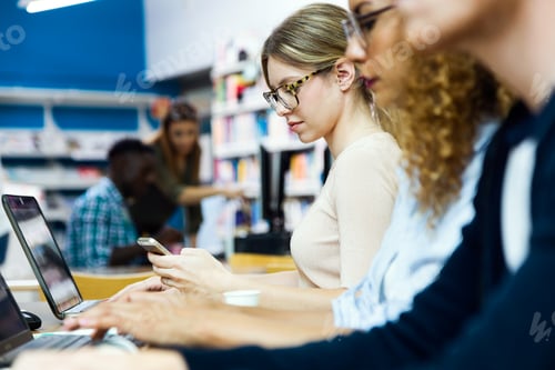 Preview: Group of friends studying in a university library.