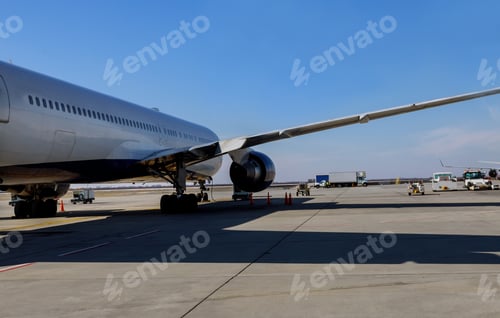 Preview: Loading aircraft at the International Airport jet engine against a middle size plane at the airport