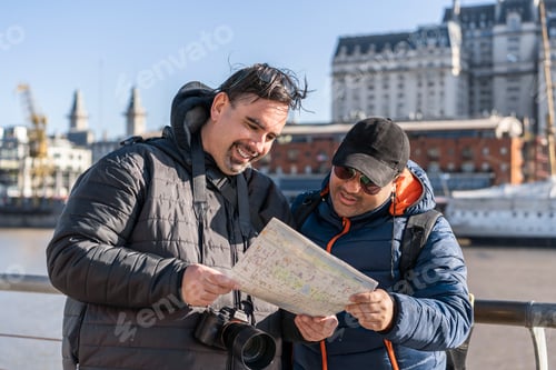 Preview: Travelers reading a map. LGBT couple. Travel friends.