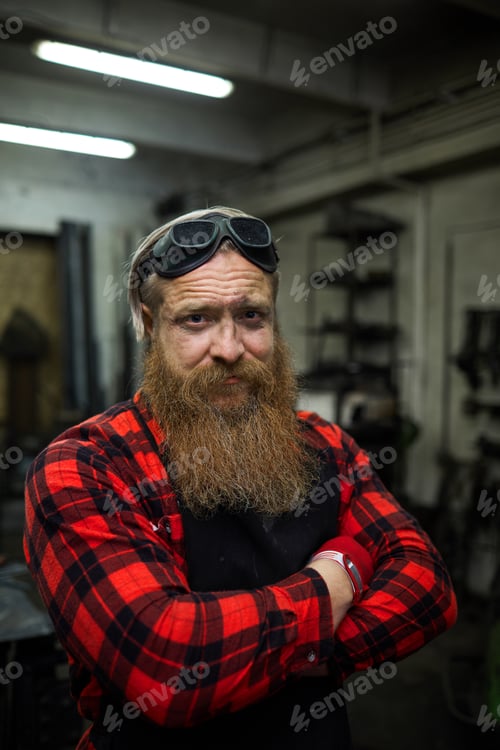 Preview: Scowling brutal blacksmith in workshop