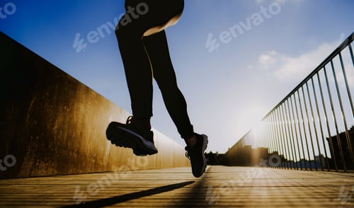Preview: Woman running on street in sunny day