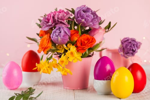 Preview: Easter colorful eggs on the background of spring flowers. Bright Easter concept.