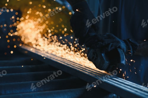 Preview: Close-up of worker cutting metal with grinder. Sparks while grinding iron. Low depth of focus