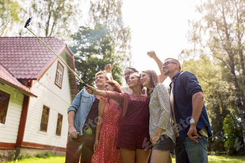 Preview: friends taking selfie at party in summer garden