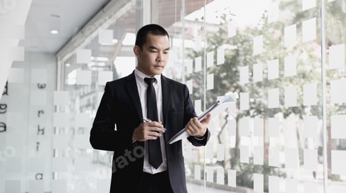 Preview: Professional Man Reads Documents in Modern Office