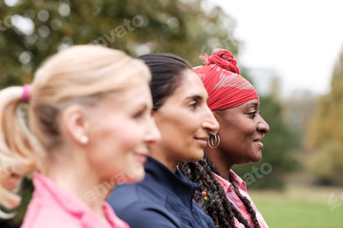 Preview: Side portrait of group of fitness mature women in park.