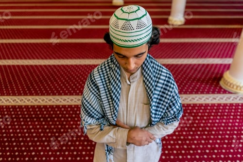 Preview: A young Muslim man in national Arabic clothing prays in a mosque during the Ramadan holiday