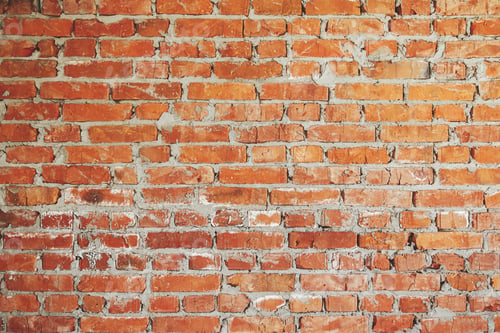 Preview: Bricks wall masonry close up with cement. Process of house building and building materials concept