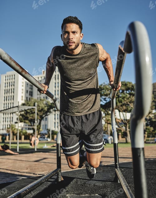 Preview: A little effort goes a long way. Shot of a muscular young man exercising at a calisthenics park.