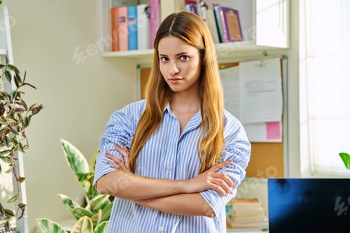 Preview: Portrait of smiling female teenager looking at camera with crossed arms in home