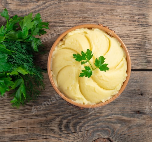Preview: Mashed potatoes, boiled puree in brown bowl on dark wooden rustic background, top view