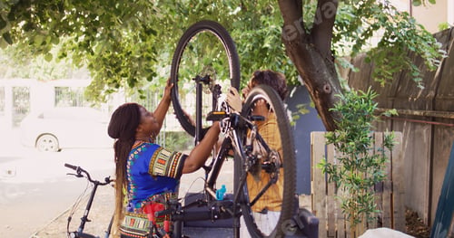 Preview: Couple attaching fixed wheel to bicycle