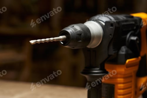 Preview: close-up and focus on the carbide tip of a drill bit inserted into a quick-change chuck