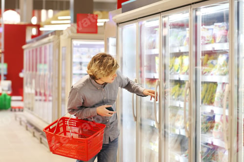 Preview: Man Choosing Frozen Food From A Supermarket Freezer