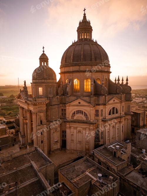 Preview: Vertical aerial of Rotunda St. John Baptist Church in Xewkija, Malta at sunset
