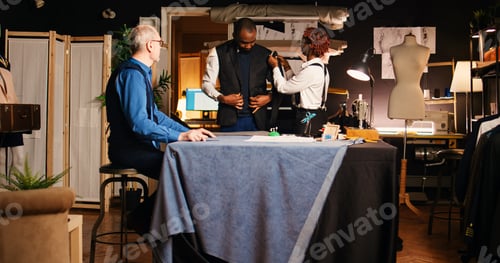 Preview: Customer fitting suit jacket in atelier