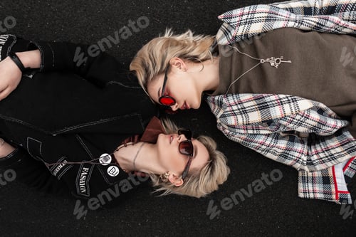 Preview: Positive beautiful woman with cute smile in clothes with sunglasses. Lovely girlfriends