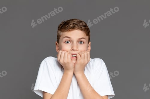 Preview: Surprised teen boy with hands on face
