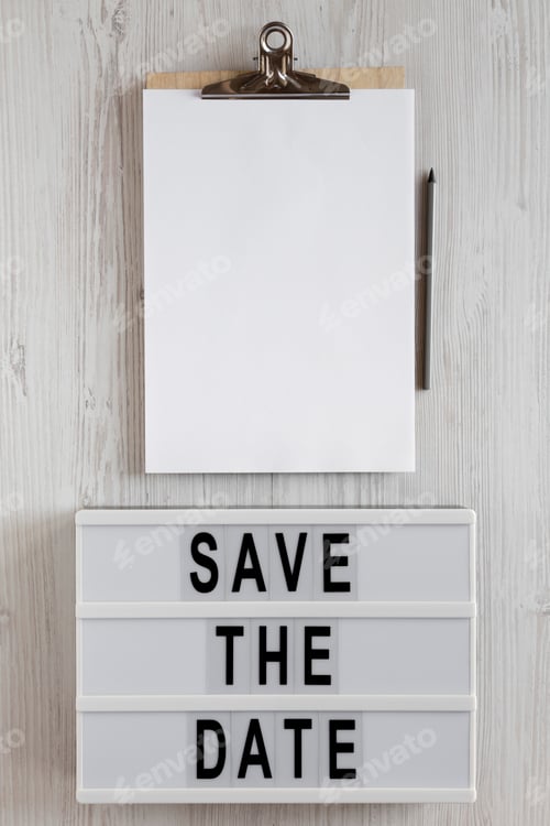 Preview: 'Save the date' words on a lightbox, clipboard with blank sheet of paper
