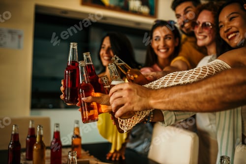 Vista previa: Happy friends are toasting drinks at a party, celebrating together