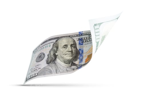 Preview: One Hundred Dollar Bill Floating Down To Surface with Drop Shadow Isolated on a White Background.