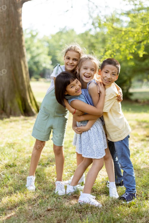 Preview: Group of asian and caucasian kids having fun in the park