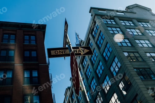 Preview: Low angle shot of "One way" and "Stop" street signs