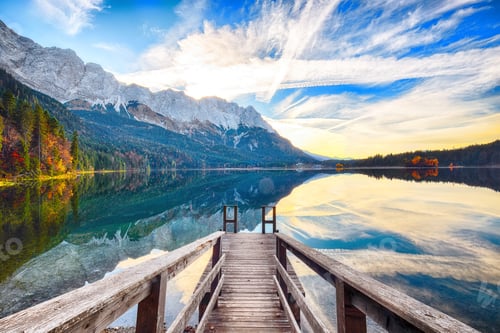Preview: Stunning autumn landscape of Eibsee Lake in front of Zugspitze summit under sunlight.