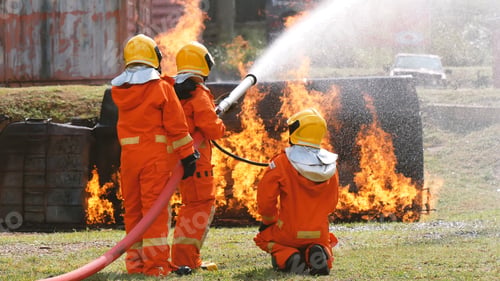 Preview: Firefighter fighting with flame using fire hose chemical water foam spray engine. Fireman hard hat