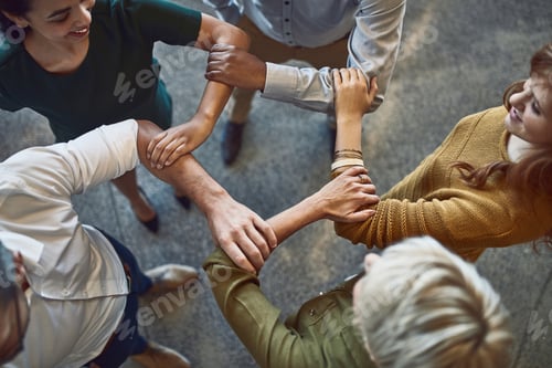 Preview: High angle shot of a group of colleagues linking arms in solidarity at work