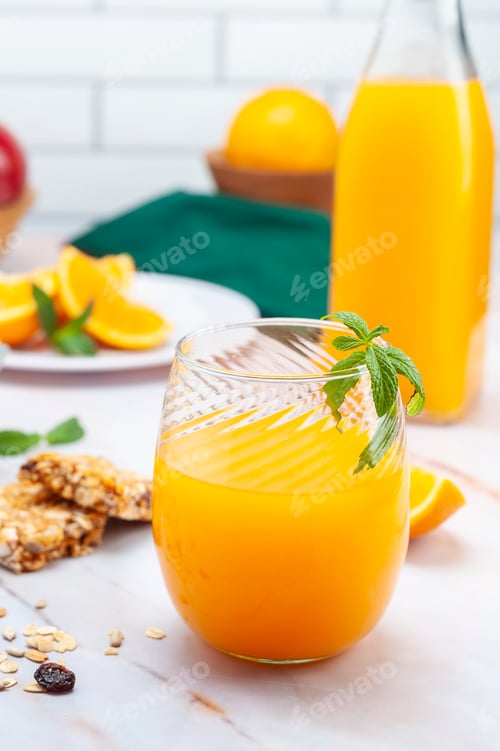 Preview: Closeup shot of a fresh juice with fruits in the background